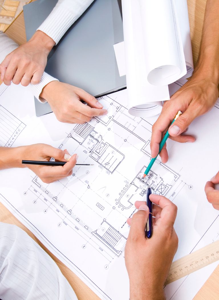 Paper building plans on a table.